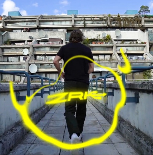 A man walking on a bridge with a building in the background